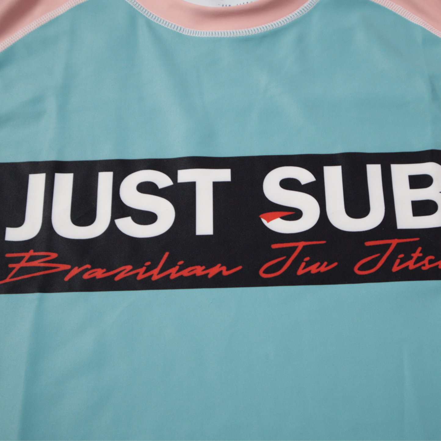 nogi bjj real teal rashguard close up logo