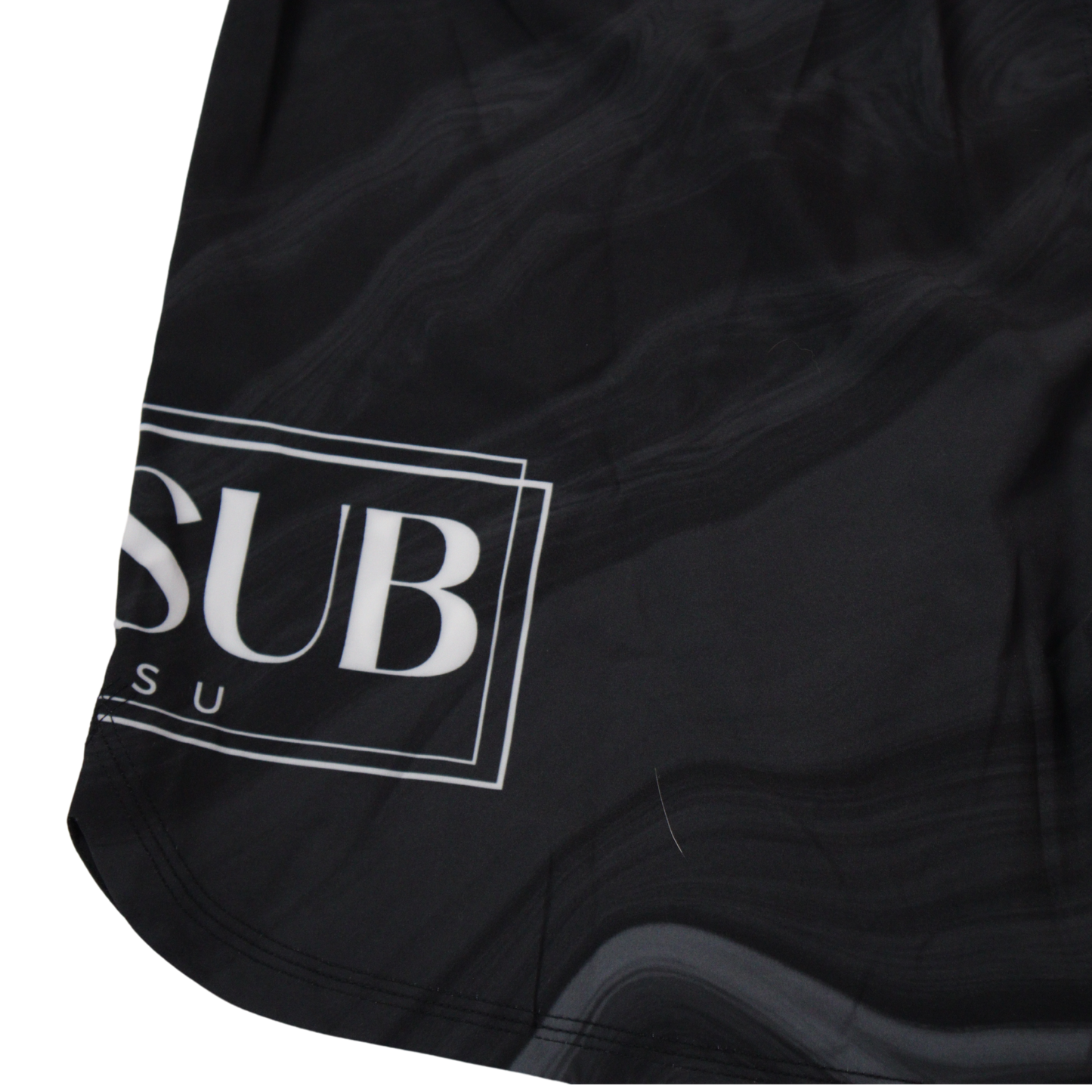 close up of marble black no gi shorts displaying company logo