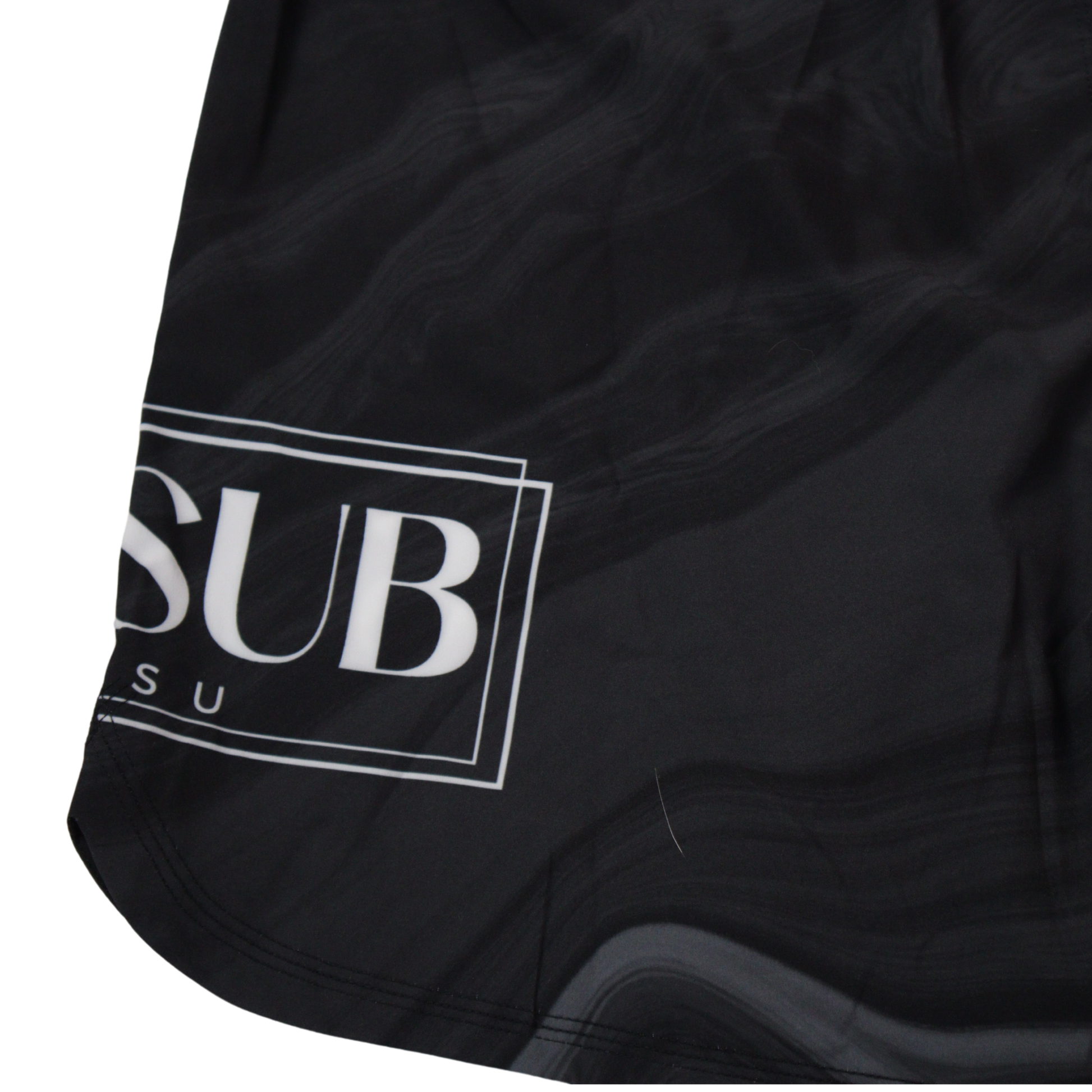 close up of marble black no gi shorts displaying company logo